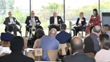 Panel presenting to an audience at the Co:Lab event